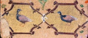 High quality image of same bird painting revealing white spotted chest feathers , yellow eyes, rough paper texture, and other details. 