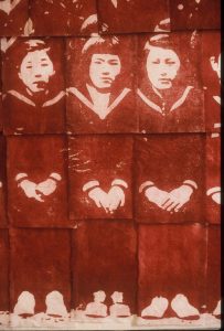 Detail showing prints of three female students as they sat with their hands clasped. 