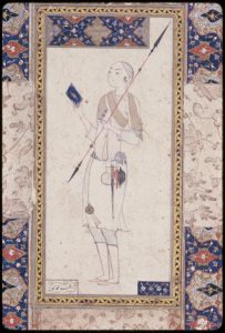 A young man is facing left against a plain background. He is holding a double-edged spear in his left hand and a book in his right. Attributes of a dervish, including a chained bell, an alms bowl, a tin water jar, and a dagger, hang from his waste. The borders are illuminated with a floral pattern and arabesques. 