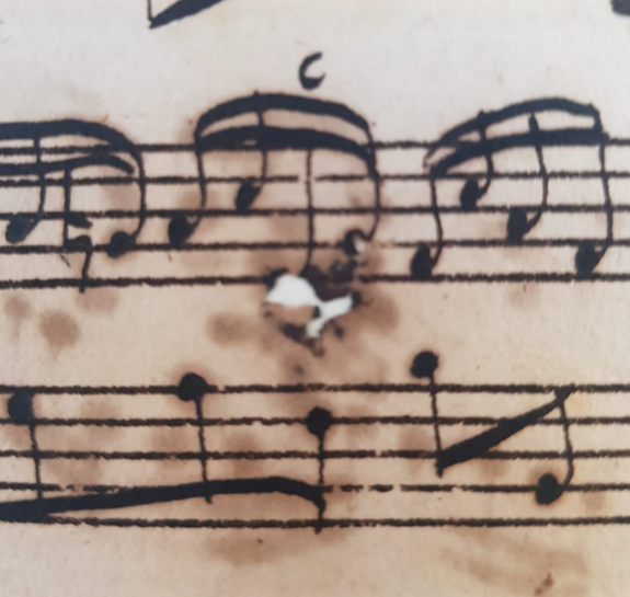 Music manuscript with iron gall ink burn